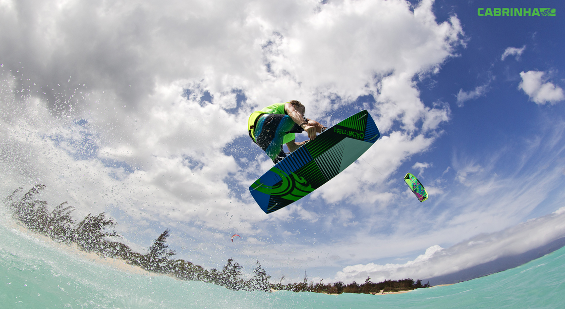 Alberto Rondina flying over tropical water on his Cabrinha kite