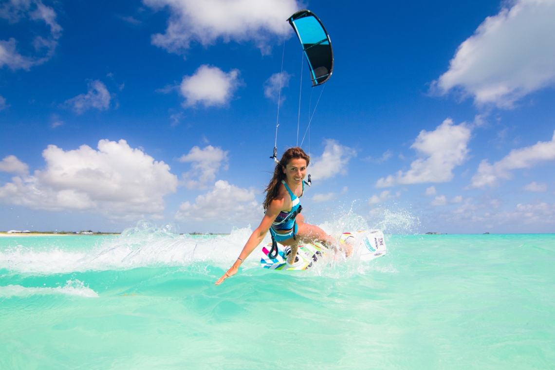 Speed queen Charlotte Consorti enjoying the tropics - kitesurfing in a blue and white bikini