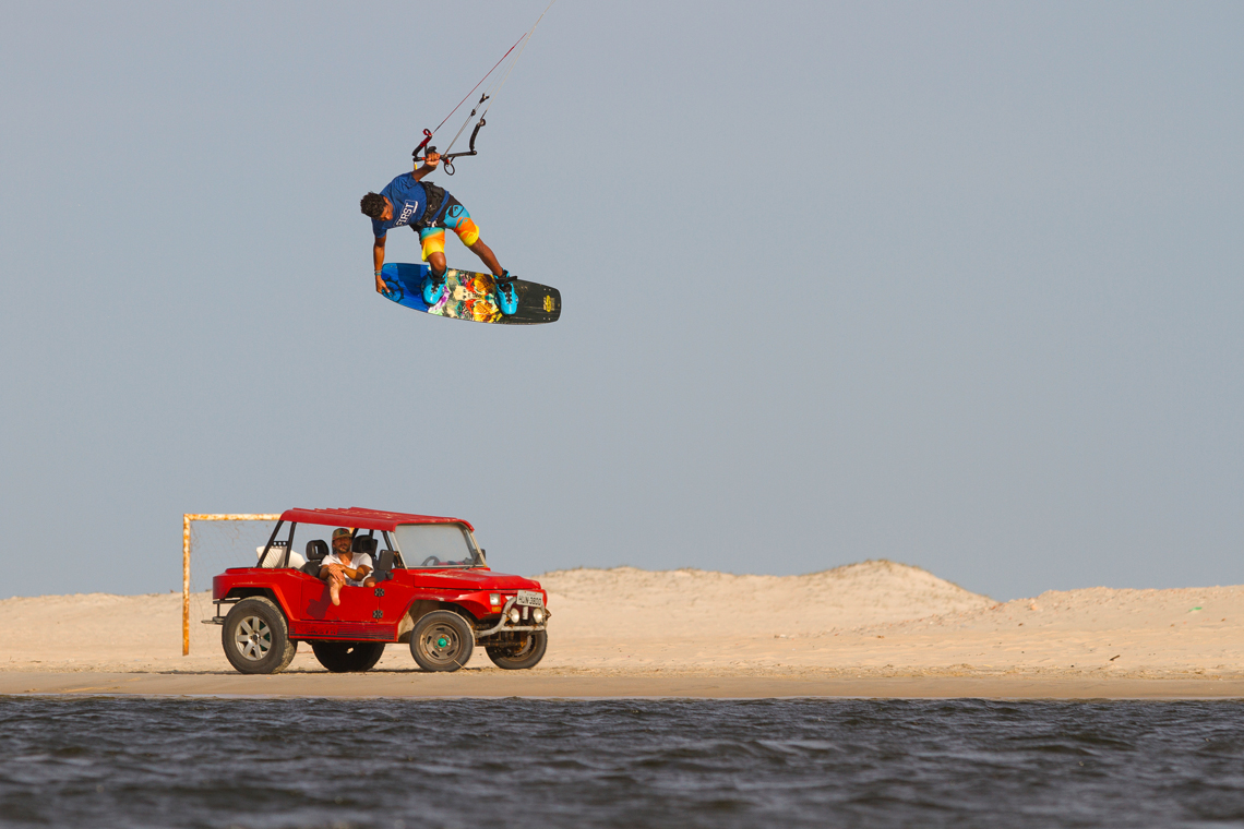 Victor Hays with a tail grab over a Brazilian buggy - Slingshot kiteboarding