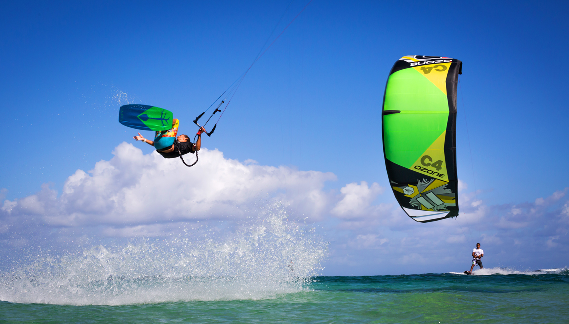 Jake Kelsick on the Tona Pop board handlepassing awefully close a C4 Ozone kite