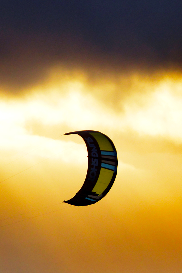 kitesurf wallpaper image - A kitesurfer cruising at sunset with his 2016 Slingshot Wave SST kite. - in resolution: iPhone 640 X 960