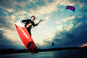 Damien LeRoy with a tailgrab at dusk on his Cabrinha kites gear