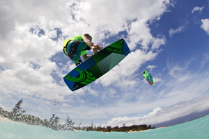 Alberto Rondina flying over tropical water on his Cabrinha kite