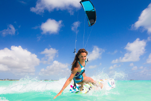 Speed queen Charlotte Consorti enjoying the tropics - kitesurfing in a blue and white bikini