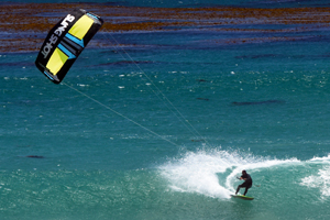 The 2016 Slingshot kiteboarding Wave SST kitesurf kite. Kitesurfer off the lip turn.