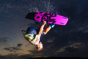 Sam Light on the 2015 Slingshot asylum board. Inverted with a grab kitesurfing.