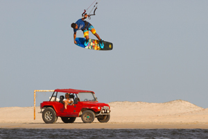 Victor Hays with a tail grab over a Brazilian buggy - Slingshot kiteboarding